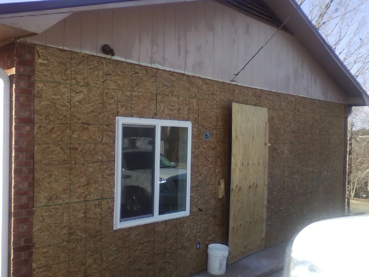 OSB sheathing on a garage addition wall before siding in Craigville